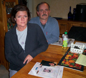 John and Monica Iliff in their Bloomington home with photos of their son. Monica is wearing a locket with a photo of Eric.