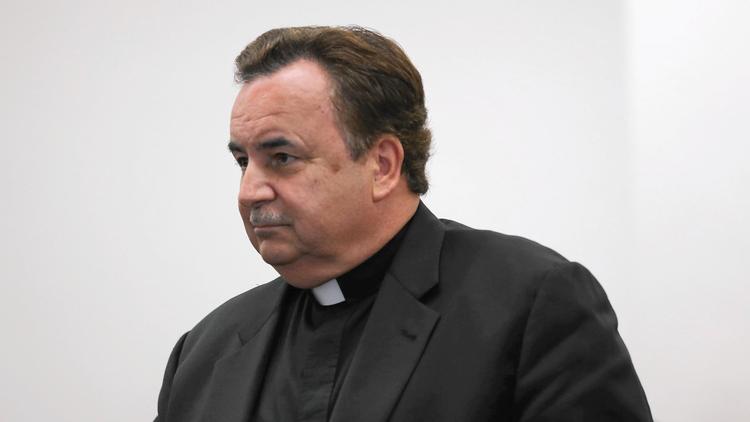 The Rev. James Dokos attends a court hearing in his criminal case July 18, 2014, in Milwaukee. Dokos, who formerly led Sts. Peter and Paul Greek Orthodox Church in Glenview, is accused of mishandling the trust fund of a Milwaukee church while he was the priest there. (Abel Uribe, Chicago Tribune)