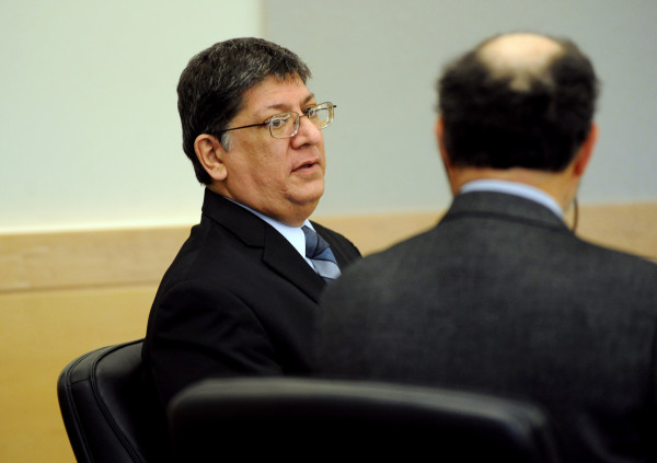 Adam Metropoulos, former Greek Orthodox priest, talks with his defense attorney, Marvin Glazier, before his trail started at the Penobscot Judicial Center, March 16, 2015. Buy Photo