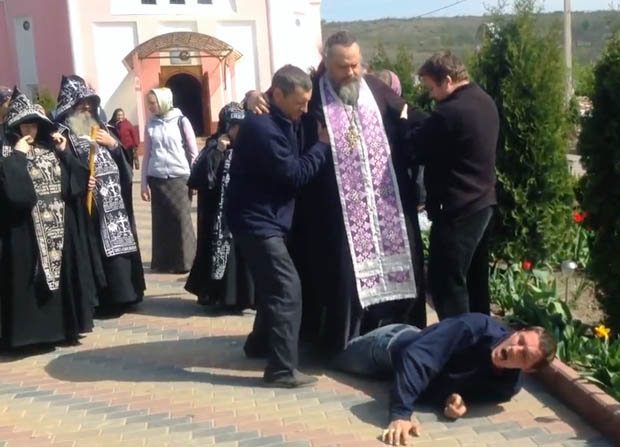 BROKEN: The man collapses under the priest's weight [CEN] 