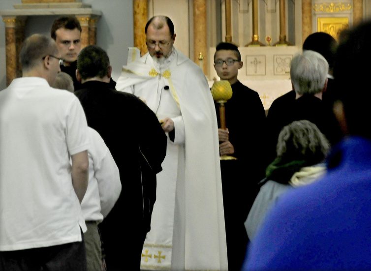 The Rev. James Doran conducts a Mass for nearly 70 parishioners Sunday at the St. Joseph Maronite Catholic Church in Waterville. Doran has taken over since Rev. Larry Jenson was recently removed over allegations of sexual exploitation of a minor 15 years ago. Staff Photo by David Leaming