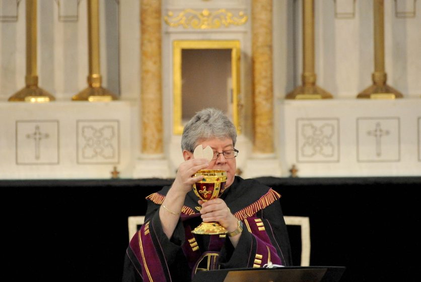 Staff file photo by Michael G. Seamans The Rev. Larry Jensen puts Communion into the Holy Chalice on April 14 during the Signing of the Chalice ritual at St. Joseph's Maronite Church on Appleton Street in Waterville.