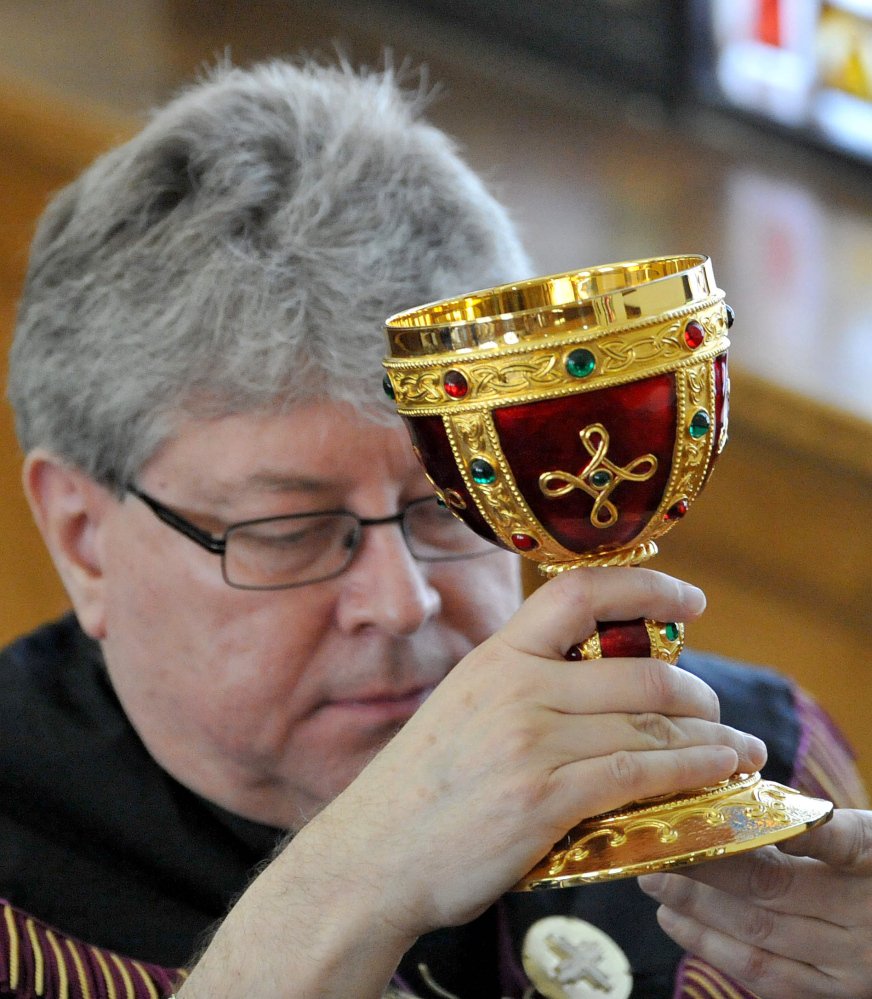 The Rev. Larry Jensen carries the Holy Chalice to the altar during the Signing of the Chalice ritual April 14 at St. Joseph's Maronite Church on Appleton Street in Waterville. Staff file photo by Michael G. Seamans