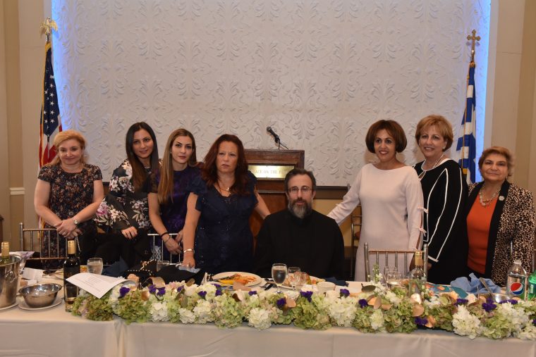 Archimandrite Gerasimos Makris surrounded by Martha Michalakos-Panagakos, Joanne Tsevdos-Esposito, Athina Giakoumis, Eleni Psaras president of the Philoptochos, Fr. Makris, Eleftheria Oikouta, Georgia Vitas, and Maria Skiadas. (Photo by TNH/Costas Bej)