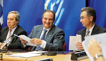 PM Costas Karamanlis (C) meets the press after an EU summit on October 16 in Brussels. He is flanked by Economy Minister George Alogoskoufis (L) and government spokesman Theodoros Roussopoulos (R).