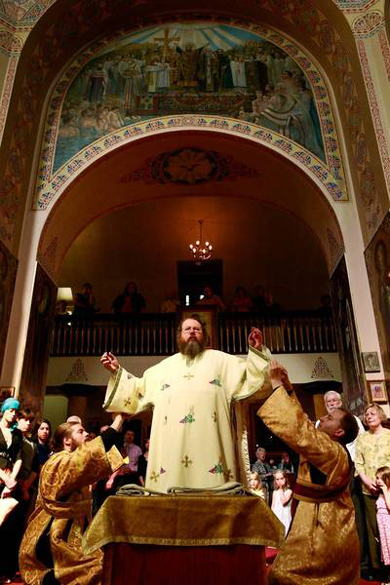 Metropolitan Jonah, center, is vested by Subdeacon Brother Gregory, left, and Subdeacon Gregory Lardin before a 2009 service at Holy Trinity Cathedral in Chicago. (Stacey Wescott, Chicago Tribune / July 26, 2009)