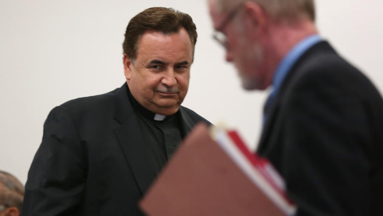Rev. James Dokos, left, and attorney Patrick Knight in a Milwaukee County courtroom on July 18. (Abel Uribe / Chicago Tribune)
