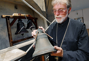 The Rev. Robert Ruark, of St. Timothy Orthodox Church in Fairfield, holds a Russian Orthodox bell in this June 2011 file photo after it was discovered that three of the church's bells were stolen. (Mike Greener/Daily Republic file 2011)