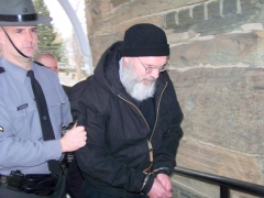 Phillip Ferrara (right), a priest at Our Lady of Solitude in Little Meadows, is led Friday into Montrose District Court for his arraignment on sex charges. Times Shamrock Photo