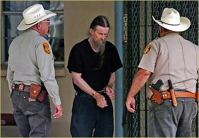 Tom Reel/Express-News:  William E. Hughes, a monk at the Christ of the Hills Monastery, is led into the Blanco County Jail on Tuesday, July 25. 