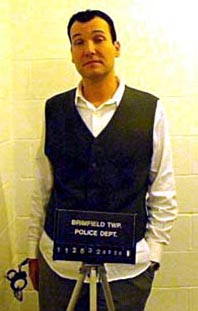 Drunk: Father Kury gets his mugshot taken before he goes on an expletive-filled rant about everything from Oprah Winfrey to Libya
