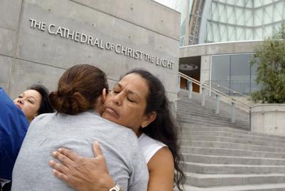 Lorene Rouse from San Leandro, right, gets a hug from supporter and SNAP member Melanie Sakoda. (Laura A. Oda./Staff)