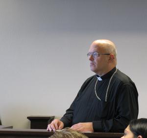 The Very Rev. Stephen Enea, archbishop of the Italo-Greek Orthodox Archdiocese of the Americas and Canada, stands in Oneida County Court on Thursday, Sept. 5, 2013, after asking for 2 weeks to consider a plea offer related to charges that he allegedly didn't pay contractors nearly $500,000 for renovations to the Italo-Greek Orthodox Archdiocesan Cathedral in Utica.  ROCCO LADUCA / Observer-Dispatch