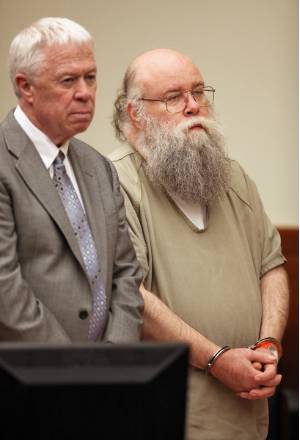 The Rev. Patrick N. Hughes, standing beside defense attorney Joseph Scott, said he pleaded guilty because he wanted to spare his church, Annunciation Greek Orthodox Cathedral, the embarrassment of a trial. Prosecutors also said a federal charge with more prison time was looming. Chris Russell/DISPATCH