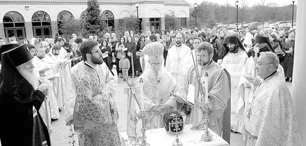 Quieter Times: The congregation of the Holy Trinity Church watches His Eminence Archbishop Demetrios, primate of the Greek Orthodox Church in America, lead the Service of Consecration on the morning of December 8, 2001 outside the north Dallas church. The dedication service for the new church edifice, which was founded in 1997, included placing relics from martyred saints in the altar. The service is a once-ina- lifetime event for a church. Rev. Nick Katinas, then pastor of Holy Trinity for 39 years, is shown to the far right. Katinas was suspended from the priesthood last July. PHOTO COURTESY OF THE DALLAS MORNING NEWS