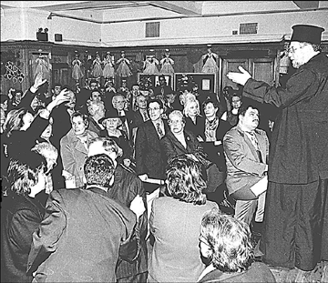 In this archive photo, Archimandrite Gabriel Karambis, right, tries to calm down the parishioners of the Holy Trinity Cathedral of NY, who were angry that former Archbishop Spyridon had replaced the popular Fr. Robert Stephanopoulos with Fr. Karambis.