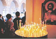 The candles lit by visitors represent their prayers and the quest for peace that drew them to the Holy Archangels Monastery.