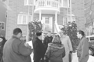 Bishop Vikentios of Apameia and his attorney George Razis make a statement to the police outside of the offices of the St. Irene Chrysovalantou Monastery in Astoria.