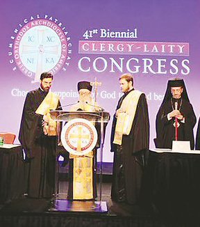 Archbishop Demetrios of America addresses the 41st Clergy-Laity Assembly. Seen above (L-R) Archdeacon Panteleimon Papadopoulos, Archbishop Demetrios of America, Deacon Aristides Garinis and Metropolitan Gerasimos of San Francisco