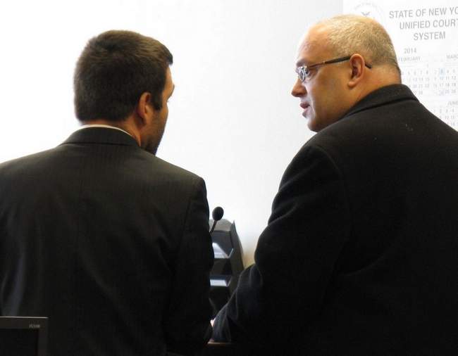 By ROCCO LADUCA / Observer-Dispatch. The Very Rev. Stephen Enea, right, talks to his public defender, Cory Zennamo, in Oneida County Court on Thursday, Mar. 6, 2014, before he was sentenced to 2 to 6 years in prison for not paying contractors for their work on the Italo-Greek Orthodox Archdiocesan church in Utica.