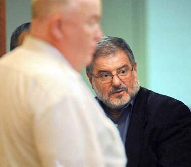 The Rev. Charles M. Abdelahad is escorted by court officers at Worcester Central District Court. (T&G Staff/TOM RETTIG)